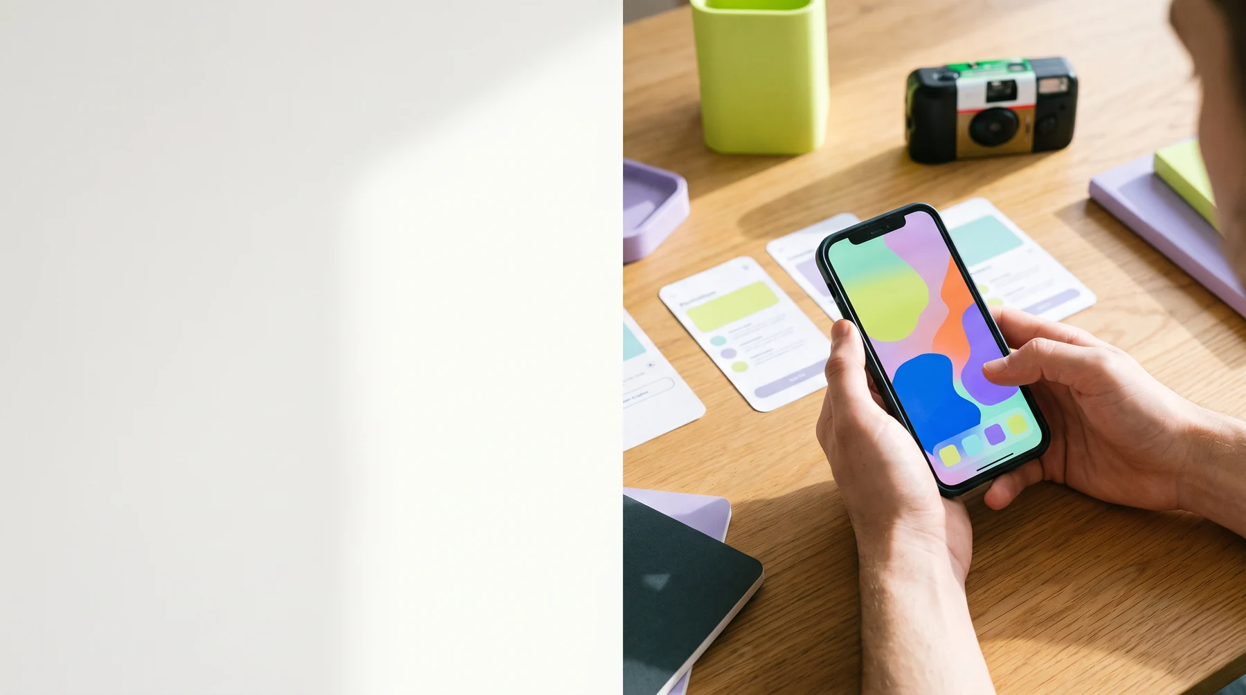 Hands using a colorful mobile app at a work table